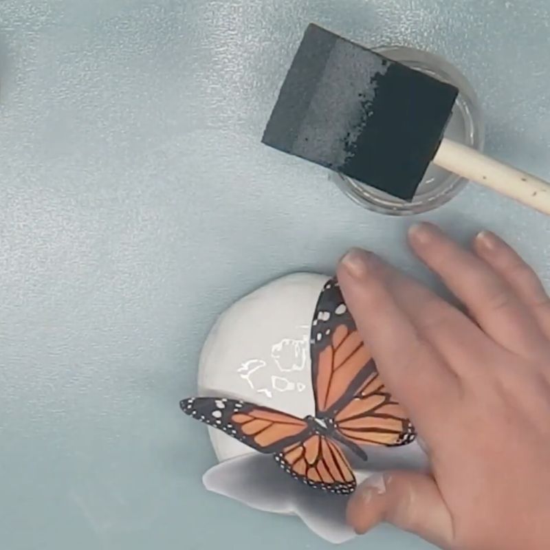 Adding a butterfly image to rock decoration.